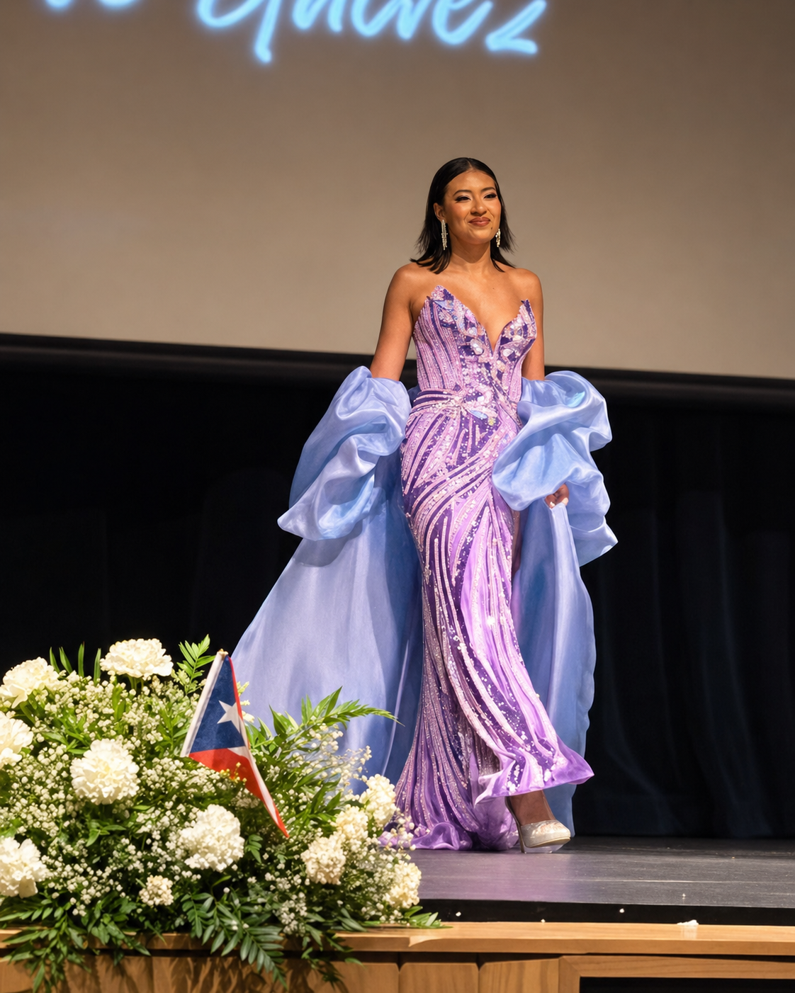 Giselle Galvez appears on stage in evening gown.